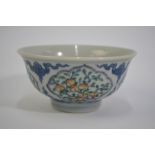 A Chinese Doucai bowl, decorated with underglaze blue cloud scrolls dividing four shaped panels of