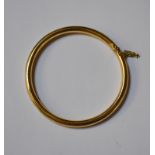 An 18ct yellow gold circular half-hinged bangle, fitted with safety chain, approx 15.8g