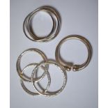 A trio of heavy silver bangles with hammered decoration, Birmingham, maker JPK to/w three Italian