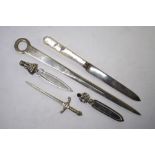 Three novelty silver bookmarks, a 'meat skewer' letter knife, Sheffield 1968, a silver-bladed letter