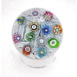 A Perthshire glass paperweight decorated with twelve large millefiori canes, including three picture