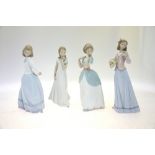 Four Lladro figures:  A Special Occasion, 8213, 2006 Events Creation, 23 cm high;  Innocence in