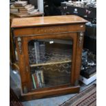 A Victorian ormolu mounted inlaid walnut pier cabinet with single arched glazed door, on a plinth