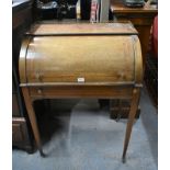 A Victorian cross-banded mahogany cylinder top desk with fitted interior over a tooled leather inset