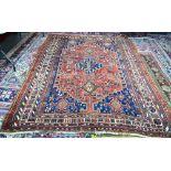 Persian Qashqai small carpet, three central medallions on red ground with animal and floral motif