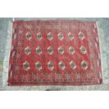 An old Turkman rug, red-brown ground with three rows of guls in brown/ivory, 150 x 108 cm