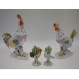 A pair of continental porcelain models of a cockerel, 26.5 cm amd chicken, 21.5 cm, both standing on