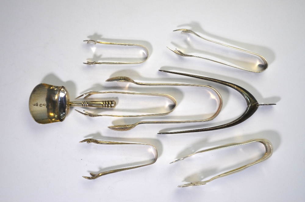 A pair of novelty silver 'wishbone' sugar tongs, Birmingham 1937 to/w a George III caddy spoon of