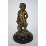 A bronze figure of a young girl holding a doll, unsigned, on turned composition plinth, 18 cm high