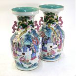 A pair of Chinese famille rose vases; each one with a turquoise interior and decorated with Daoist
