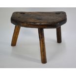 An antique elm seat tripod dairy stool, stamped with initials 'SR', 37 x 24 x 26 cm h