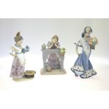 Three Lladro figures:  Girl in Spanish dress holding a basket of flowers, 5490, 1987, 25 cm high;