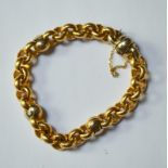 A yellow metal cable chain bracelet with yellow and white metal balls at intervals, with ball clasp,