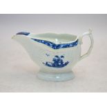 An 18th century Worcester blue and white strap moulded sauce boat decorated with scrolled and