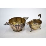 A late Victorian silver sugar basin of lobed form, with twin pierced handles and moulded foot,