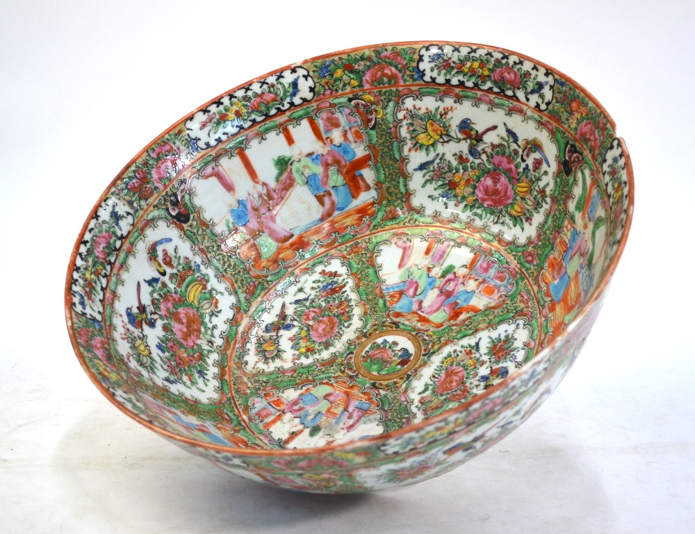 A large Canton famille rose punch bowl, decorated with typical panels depicting Natural History