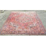 Persian Heriz carpet, large central rosette medallion and stylized floral design within repeating