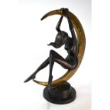 A large Art Deco style bronze sculpture, a crescent moon with a nude female figure suspended, raised