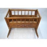 An antique continental pine cradle, polychrome decorated, on rockers, 90 cm h