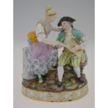 A Meissen figural group depicting a couple feed a lamb, seated on a rocky base with a dog to the