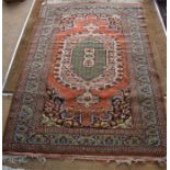 A Persian Tabriz rug, the burnt orange ground centred with a green ground medallion, with kelim