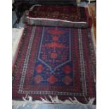 An old Afghan Belouch rug, blue ground with geometric design in red/brown, 205 x 110