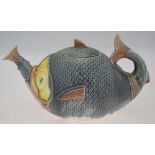 A Majolica style teapot and cover, designed as a large fish swallowing a smaller fish, about 16 cm