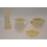 Four pieces of Belleek including a tyg decorated with shamrocks, 8 cm high and a basket weave