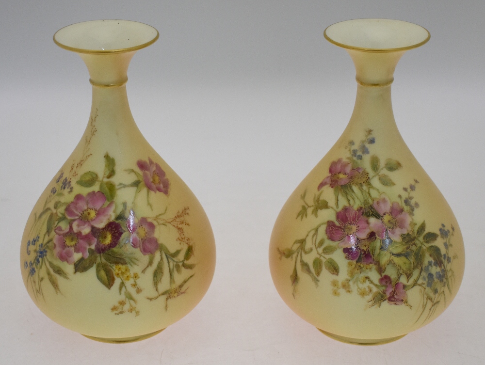 A pair of Royal Worcester blush ground floral decorated vases, date cypher 1912, shape 293, 19 cm