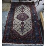 An old Persian Malayer rug, the lattice design centred by a lozenge medallion on camel ground, 180 x