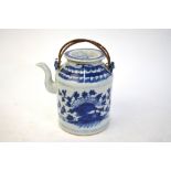 A Chinese blue and white teapot of cylindrical form with circular cover, decorated with floral