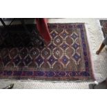 An antique Belouch rug, the red-brown ground with alternating design of guls, 180 x 100 cm