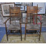 A pair of Arts & Crafts period Liberty style country carvers, elm with rope seats, in unrestored