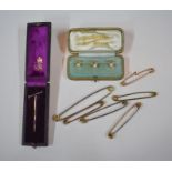 A set of three yellow gold pearl set dress studs, stamped 18ct, cased to/w bugle stick pin (cased)