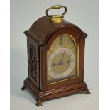 A George III  twin fusee walnut cased mantel clock, the arched dial with gilt spandrels and silvered