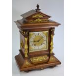 A German walnut cased mantle clock, the movement striking the hours on a spiral gong signed