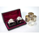 A Victorian cased pair of silver napkin rings, cast with the shield and motto of the