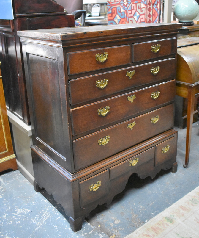 An 18th century oak chest on stand with two short, three long graduated drawers, the stand with