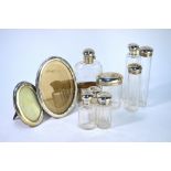 An Edwardian cut glass hip-flask with silver hinged bun cover and detachable beaker, Thomas