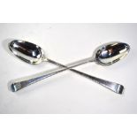 A pair of early George III silver feather-edge basting spoons with lion and sword crest, (