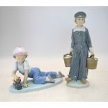 Two Lladro figures - Dutch boy carrying milk pails, 22.5 cm high and a Boy playing with a model