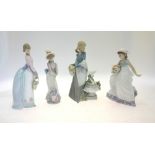 Four Lladro figures:  Girl with Flowers, 5799, signed to base and dated 21-6-91, 22.5 cm;  In the