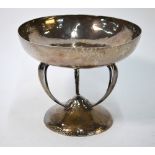 An Edwardian Scottish Art Nouveau planished silver comport with bowl raised on three organic '