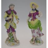 A pair of continental porcelain figures of a lady and gentleman in 18th century costume, probably