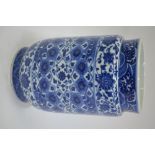 A modern blue and white vase of cylindrical form, decorated with a typical design of wave, sea