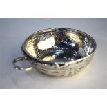 A late 18th Century French white metal taste-vin with snake ring handle and nail-punch decoration,