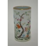 A famille rose bitong of cylindrical form, decorated with flowers in a garden, gilt rim, 12.5 cm