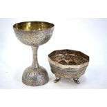 An Indian or Persian white metal double measure of goblet form, 12 cm high, decorated with floral