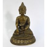 A gilt metal figure of the Mahayana Buddhist Deity, Amitabha, seated on a lotus base in dhyanasana