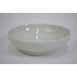 A modern, small white monochrome dish of circular form; 9 cm diameter, underglaze blue Qianlong